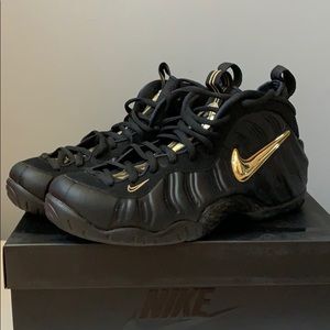 Nike black with gold trim Foamposite